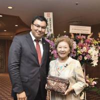 Uzbekistan\'s chairman of the state committee for tourism development, Aziz Abdukhakimov (left), poses for a photo with Kyoko Nakayama, former ambassador to Uzbekistan and Upper House lawmaker, during a reception to celebrate the country\'s independence day at Hotel Okura, Tokyo on Sept. 22. | YOSHIAKI MIURA