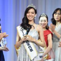 Keio University senior Haruka Yamashita smiles Monday in Tokyo after being selected to represent Japan at the Miss World pageant, to be co-hosted by Singapore and China between Oct. 16 and Nov. 18. | KYODO