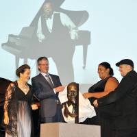 Canadian Ambassador Ian Burney (second from left) and Celine Peterson (second from right) unveil a bronze bust of jazz painist Oscar Peterson at the Canadian Embassy on Sept. 1. Sculptor Ruth Abernethy (left) and jazz pianist Robi Botos were on stage to witness the event. | YOSHIAKI MIURA