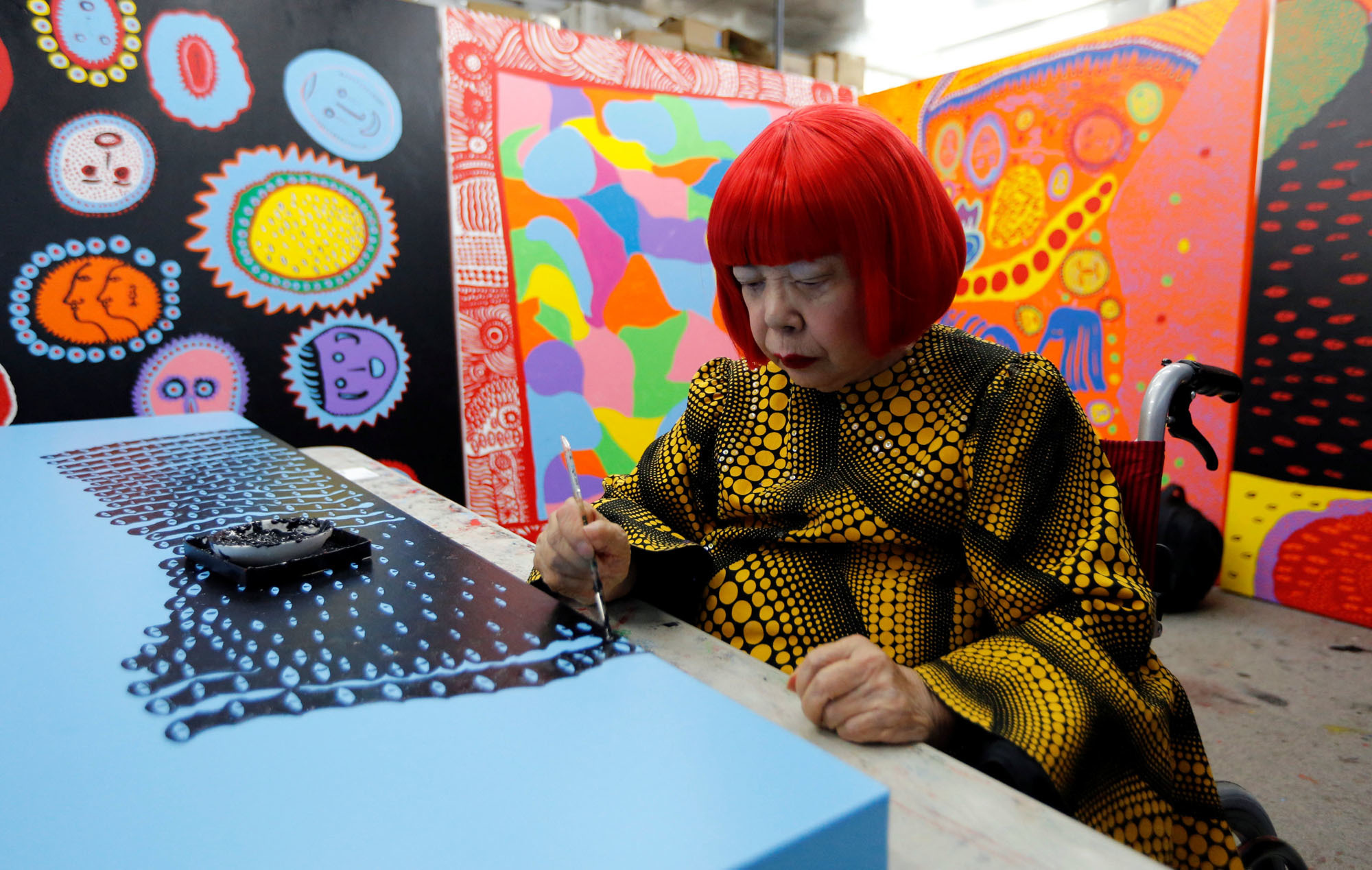 Avant-garde artist Yayoi Kusama, 88, speaks to the media at her studio in Tokyo on Tuesday. Kusama, whose exhibitions have been among the hottest tickets in the art world, is now opening a museum in downtown Tokyo dedicated to her paintings and sculptures. | REUTERS