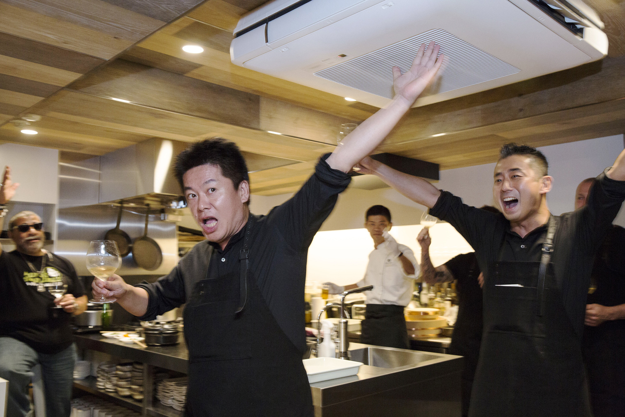 Takafumi Horie (left) and Hisato Hamada raise a toast at Wagyumafia, a members-only restaurant in Tokyo, on Sept. 28. | BLOOMBERG