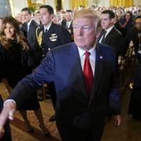 U.S. President Donald Trump and his wife, Melania, leave the East Room of the White House in Washington on Thursday after speaking on the country\'s opioid crisis. | AP