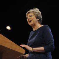Prime Minister Theresa May addresses delegates during a speech at the Conservative Party Conference in Manchester, England, on Wednesday. | AP