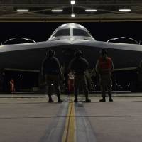 Airmen inspect a B-2 bomber before it takes off Saturday from Whiteman Air Force Base in Missouri for a long-range mission to the U.S. military\'s Pacific area of responsibility over the weekend. | U.S. AIR FORCE