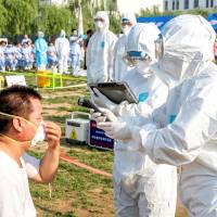 People participate in an emergency exercise on prevention and control of the H7N9 bird flu virus organized by the Health and Family Planning Commission of the local government in Hebi, Henan province, China, in June. | REUTERS