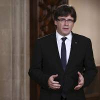 Catalan President Carles Puigdemont speaks during a statement at the Palau Generalitat in Barcelona, Spain, on Wednesday. Catalonia\'s regional president, Puigdemont, is addressing regional lawmakers on Monday to review a referendum won by supporters of independence from Spain last Sunday. | JORDI BEDMAR / PRESIDENCY PRESS SERVICE, POOL PHOTO / VIA AP