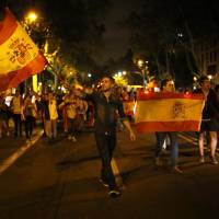 Anti-independence demonstrators waving Spanish flags march blocking main Diagonal avenue during a protest in Barcelona, Spain, Wednesday. Catalonia\'s regional government is mulling when to declare the region\'s independence from Spain in the wake of a disputed referendum that has triggered Spain\'s most serious national crisis in decades. | AP