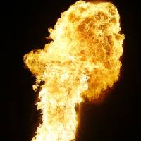 A reveler spits fire in a \"correfoc\" (\"run with fire\") party on Saturday in Cornella Llobregat, on the outskirts of Barcelona. Correfocs originated as medieval street theater that represented the fight of good against evil. | AP