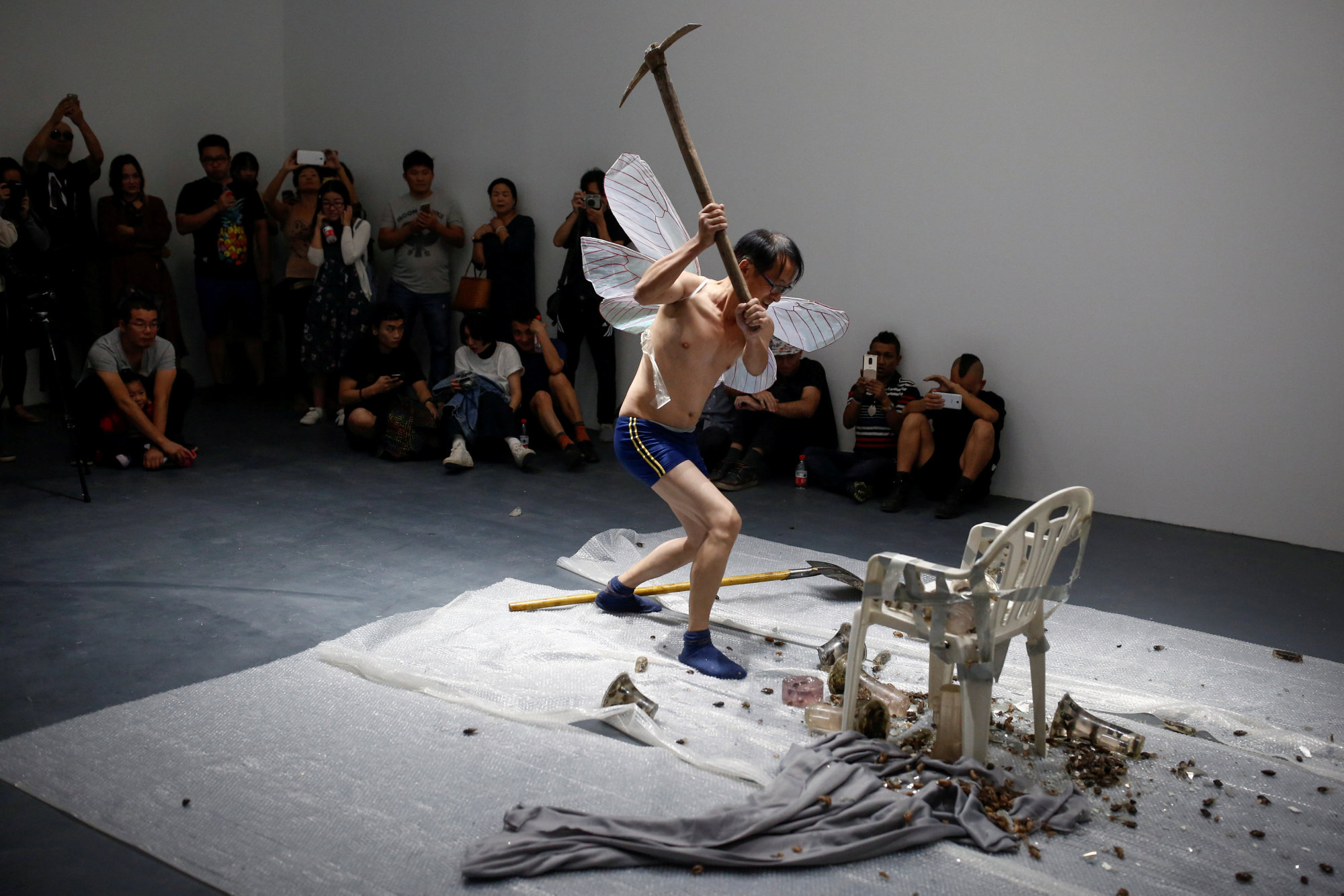 Huang Wenya, a Chinese performance artist, smashes objects as he performs 'Aftersound' at the OPEN international performance art festival in the Songzhuang art colony near Beijing in September. | REUTERS