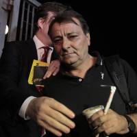 Cesare Battisti leaves the Federal Police headquarters on March 13, 2015, in Sao Paulo. Battisti, sentenced to life in prison for homicide in his country, was arrested on Wednesday in Brazil, on the border with Bolivia, a spokesman for the Federal Police said. | AFP-JIJI