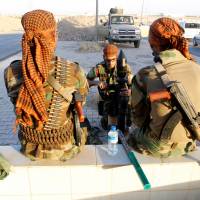 Kurdish Peshmerga fighters gather north of Kirkuk, Iraq, Thursday. | REUTERS