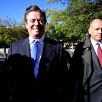 U.S. President Donald Trump\'s former campaign manager, Paul Manafort (left), departs U.S. District Court after a hearing in the first charges stemming from a special counsel investigation of possible Russian meddling in the 2016 presidential election, in Washington Monday. | REUTERS