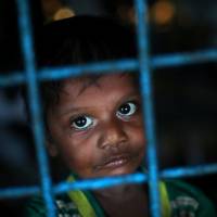 A Rohingya refugee boy, who crossed the border from Myanmar this week, takes shelter at Long Beach Primary School, in the Kutupalong refugee camp, near Cox\'s Bazar, Bangladesh, on Monday. | REUTERS