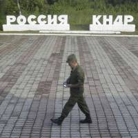 A guard walks along a platform past signs which read \"Russia\" (left) and \"DPRK\" at the border crossing between Russia and North Korea in the settlement of Tumangan, North Korea. DPRK stands for the North\'s formal name, the Democratic People\'s Republic of Korea. | REUTERS