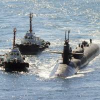 The nuclear-powered submarine USS Michigan approaches a naval base in Busan, South Korea, on Friday. | NEWSIS / VIA AP