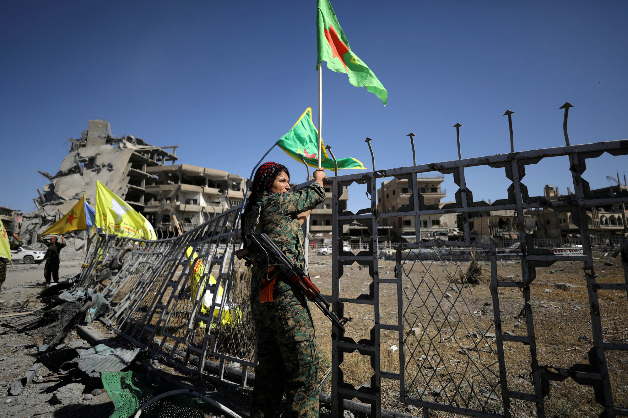 A female fighter of the Syrian Democratic Forces is seen in Raqqa, Syria, on Tuesday. | REUTERS