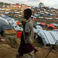 A Rohingya boy walks at a refugee camp near Cox\'s Bazar, Bangladesh, Wednesday. | REUTERS