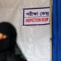 A Rohingya refugee sits in a waiting room at a women\'s clinic in Balukhali refugee camp near Cox\'s Bazar, Bangladesh, Monday. | REUTERS