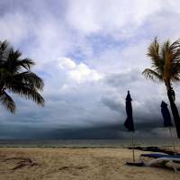 Black clouds are seen on the horizon from a beach in Cancun, Mexico, on Friday, ahead of the passage of Tropical Storm Nate. | AFP-JIJI