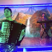 Korean waitresses play music at the Pyongyang Okryu-Gwan North Korean Restaurant in Dubai, United Arab Emirates, in July. The United Arab Emirates says it will stop issuing new visas to North Korean laborers, becoming the latest Gulf country to cut back on ties to Pyongyang amid tensions between North Korea and the U.S. The announcement by the UAE Foreign Ministry on Thursday did not address the thousands of North Korean laborers already working in the Emirates. | AP