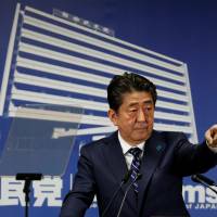 Prime Minister Shinzo Abe, who is also leader of the Liberal Democratic Party, is seen at a news conference at LDP headquarters in Tokyo on Monday. | REUTERS