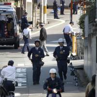Police investigate the site where a car hit students and a teacher on Wednesday in Hirakata, Osaka Prefecture. | KYODO