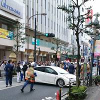 A car is seen near where it crashed into a guardrail Friday after hitting pedestrians in front of the Tokyu Department Store in Kichijoji in western Tokyo. | KYODO