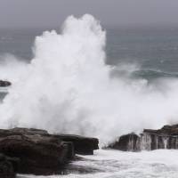 High waves batter the coast of Shirahama, Wakayama Prefecture, on Sunday as Typhoon Lan approached. Municipalities with remote islands were unable to start tallying votes as the powerful storm halted ferry services, preventing ballots from being delivered to the mainland. | KYODO