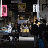 A worker drives an electric forklift in the Tsukiji fish market in Tokyo. The market has long been a home for hordes of rats, with a constant supply of fish scraps and plenty of hidden nesting places. | BLOOMBERG