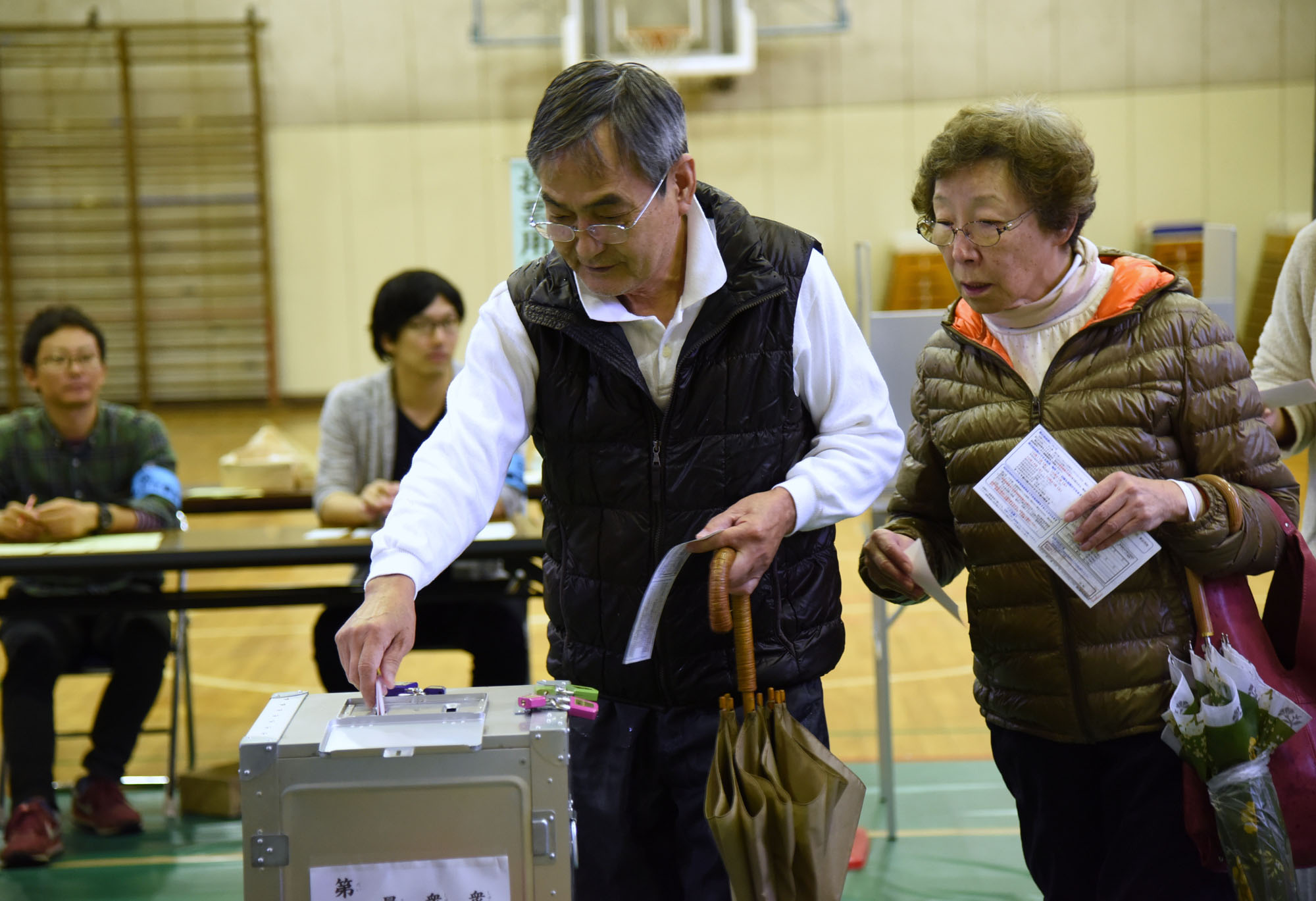 People cast ballots in the Lower House election at a polling station in Minato Ward, Tokyo, on Sunday. | SATOKO KAWASAKI