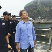 Moon Jae-in, then former leader of the Minjoo Party of Korea, visits Takeshima in July 2016 before being elected president of South Korea, which controls and calls the island Dokdo. | YONHAP NEWS AGENCY / VIA KYODO