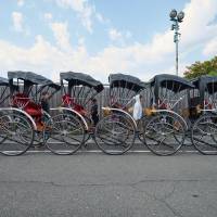 Rickshaws line up on a street in the Arashiyama tourist spot in the city of Kyoto. Spending by foreign visitors to Japan is expected to set a new record this year, according to the Japan Tourism Agency. | YOSUKE NAITO