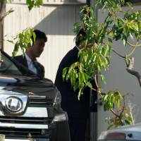 Police investigators enter the office of a company operating the Ripple cryptocurrency exchange in Hamamatsu, Shizuoka Prefecture, on Wednesday. Police arrested the same day Yuki Takenaka, the founder and head of the company, for allegedly swindling &#165;1.4 million from a depositor. | KYODO