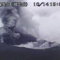 Mount Shinmoe, straddling the Miyazaki and Kagoshima prefectural border, spews ash after erupting again on Saturday. | KYODO