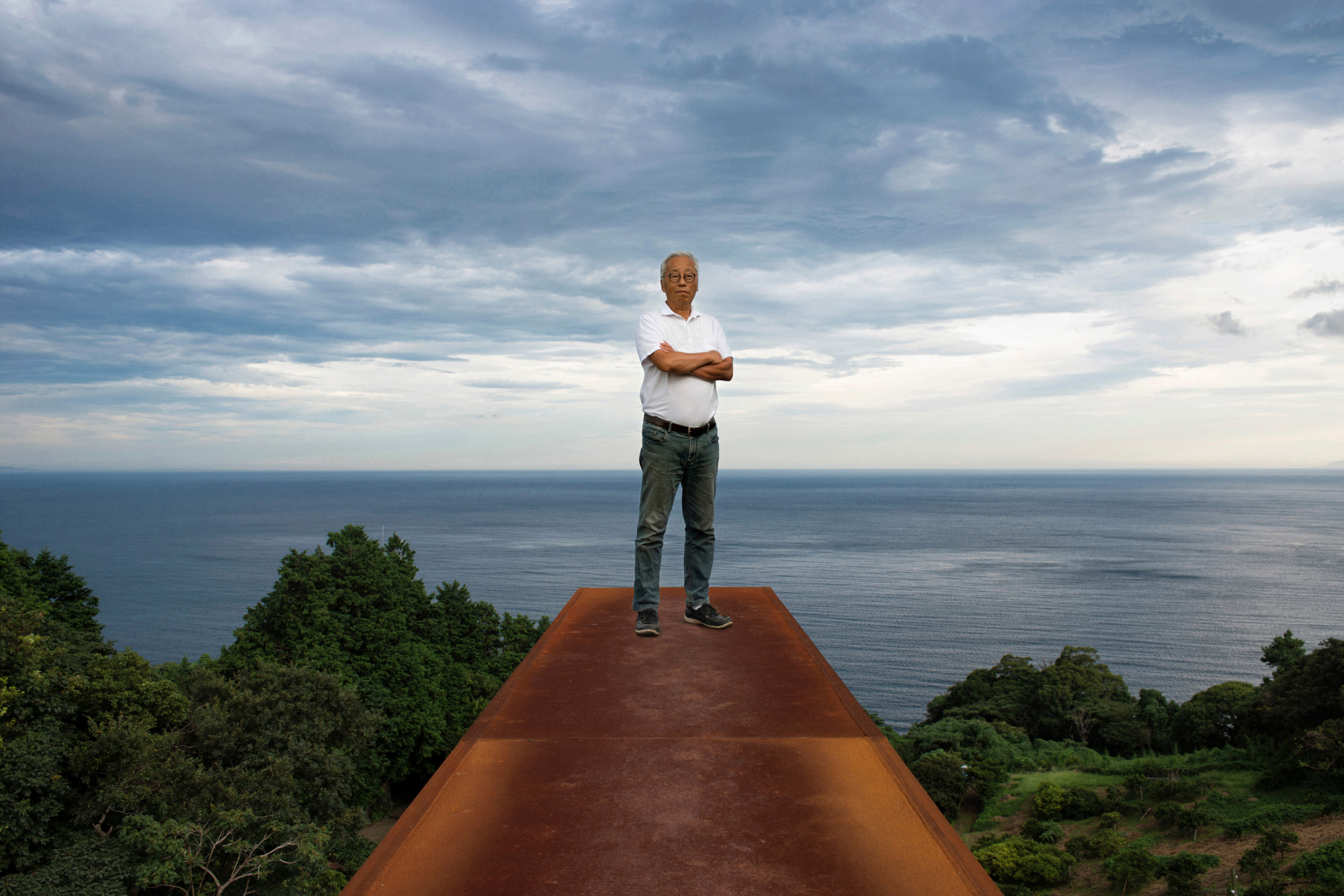 Home by the sea: Artist Hiroshi Sugimoto stands atop a 70-meter rectangular chamber made from CorTen weathering steel that starts underground and ends up as a sheer drop overlooking the ocean at the Enoura Observatory, Kanagawa Prefecture. It is angled to capture the winter solstice. | ROB GILHOOLY