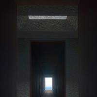The interor of a steel chamber overlooking the ocean has a well at its center. | ROB GILHOOLY