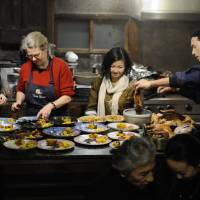Hearty spread: The author (second from left) and friends serve up Thanksgiving dinner at her home in Kamikawa, Saitama Prefecture. | NANCY SINGLETON HACHISU