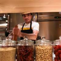 Isan all the way: The som tum chef at Somtum Der prepares the sweet-sour-spicy green papaya salad. | ROBBIE SWINNERTON