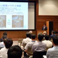 Naoki Suganuma, the head of Kanazawa University\'s Autonomous Vehicle Research Unit, gives a lecture at Nifco Hall in Tokyo\'s Minato Ward on Sept. 15. | YOSHIAKI MIURA
