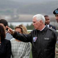 U.S. Vice President Mike Pence inspects the Korean Demilitarized Zone on April 17. Such front-line visits are viewed as reaffirming the U.S.-South Korean defense pact. | BLOOMBERG