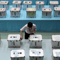 Poll position: An electoral official prepares ballot boxes for the general election in Himeji, Hyogo Prefecture, on  Oct. 22. | BLOOMBERG