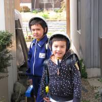 Hard-hat policy: In rural Gifu Prefecture, the author\'s sons were required to wear hard helmets for the five-minute walk to and from school. Rules such as these didn\'t go down well with Vincent (left), so his parents decided to enroll him in a Vermont-based virtual school rather than the local junior high. | JOHN SPIRI
