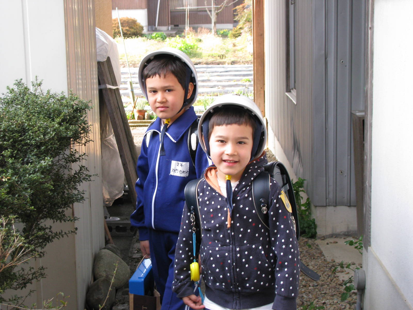 Hard-hat policy: In rural Gifu Prefecture, the author's sons were required to wear hard helmets for the five-minute walk to and from school. Rules such as these didn't go down well with Vincent (left), so his parents decided to enroll him in a Vermont-based virtual school rather than the local junior high. | JOHN SPIRI
