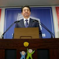 Prime Minister Shinzo Abe attends a news conference at LDP headquarters in Tokyo on Monday following his ruling coalition\'s victory in Sunday\'s Lower House election. Abe will meet with U.S. President Donald Trump in the first week of November. | REUTERS