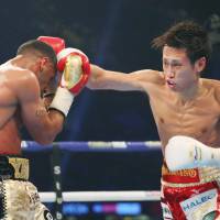 Sho Ishida throws a punch at Britain\'s Khalid Yafai during their WBA super flyweight world title fight on Saturday in Cardiff, Wales. | KYODO