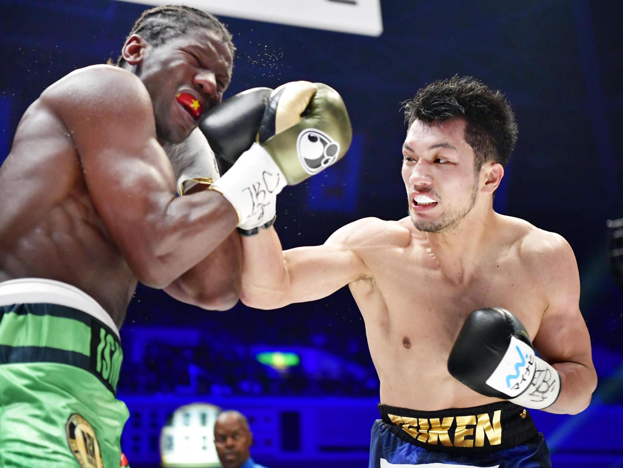 Ryota Murata lands a punch on Hassan N'Dam during their WBA middleweight world title fight on Sunday at Ryogoku Kokugikan. | KYODO
