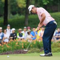 Hideki Matsuyama putts on the 12th hole during the second round of the CIMB Classic on Friday in Kuala Lumpur. He shot a 4-under 68. | KYODO
