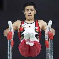 Kenzo Shirai performs on the parallel bars during the individual all-around final at the world championships in Montreal on Thursday. | AP