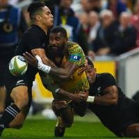 Australia\'s Marika Koroibete passes the ball during the Wallabies\' 23-18 win over the All Blacks on Saturday in Brisbane. | AFP-JIJI