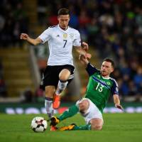 Germany’s Julian Draxler is tackled by Northern Ireland’s Corry Evans during their World Cup qualifier at Windsor Park in Belfast on Thursday night. | REUTERS